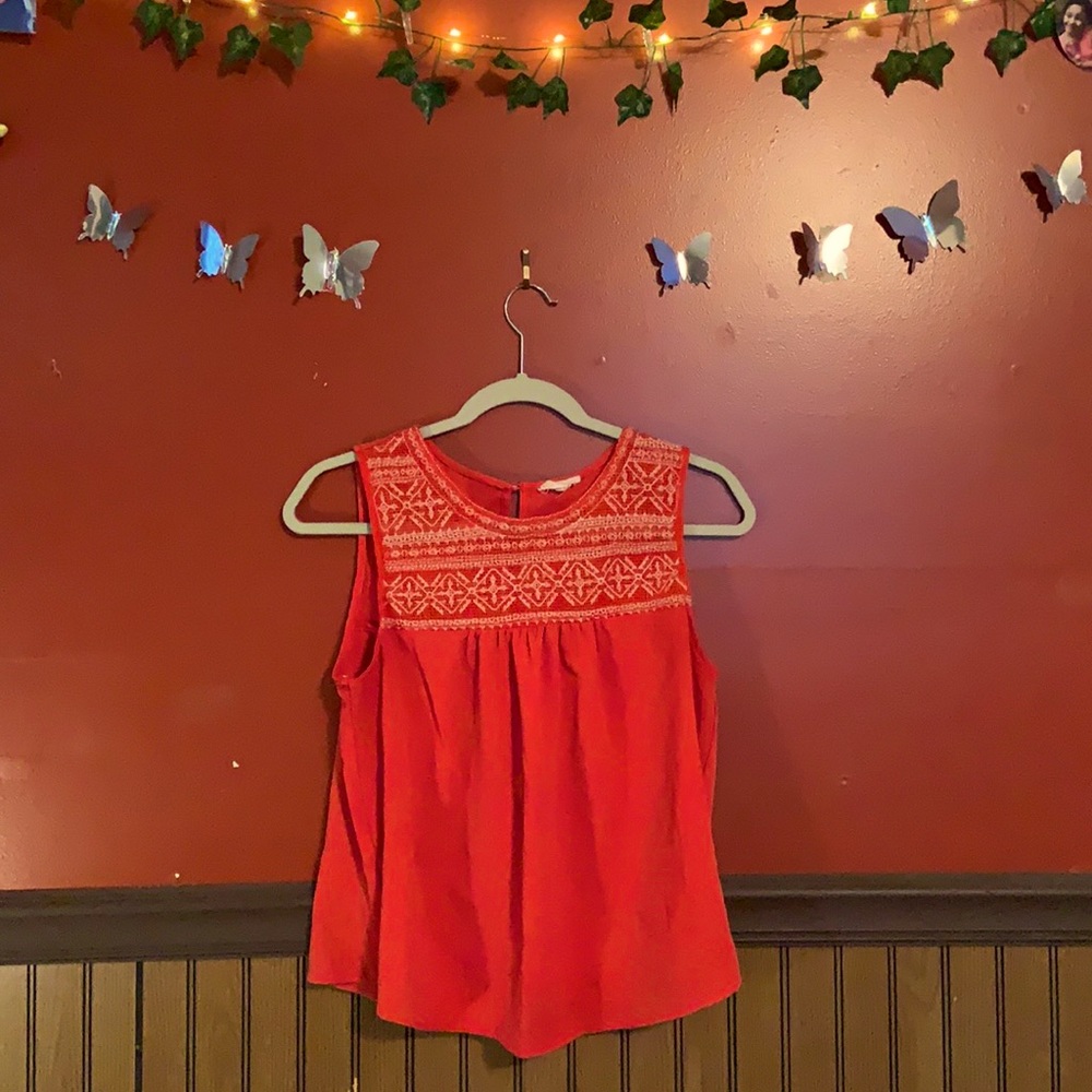 It’s a coral color with a white design.